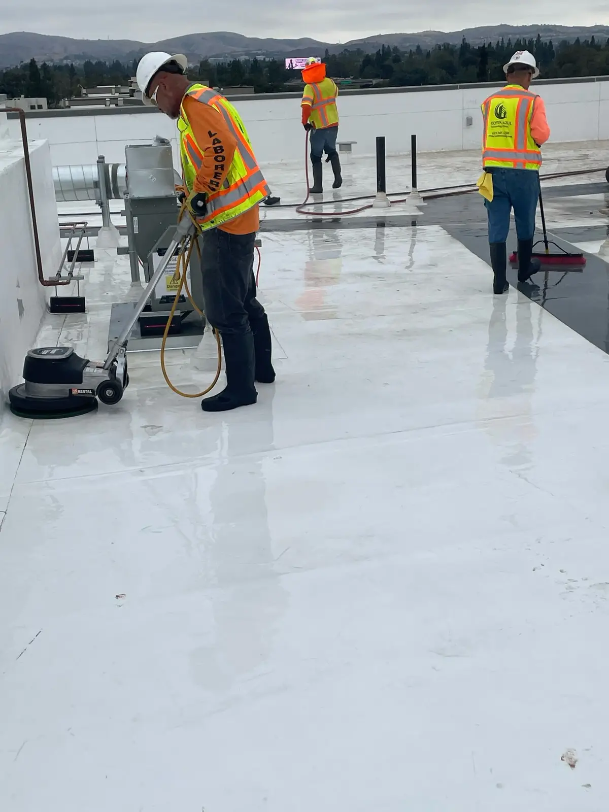 Crew on roof membrane with full safety harness